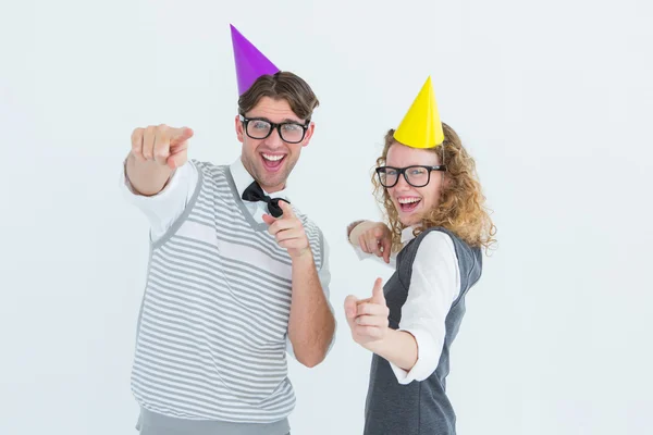 Happy geeky hispser couple dancing with party hat — Stock Photo, Image