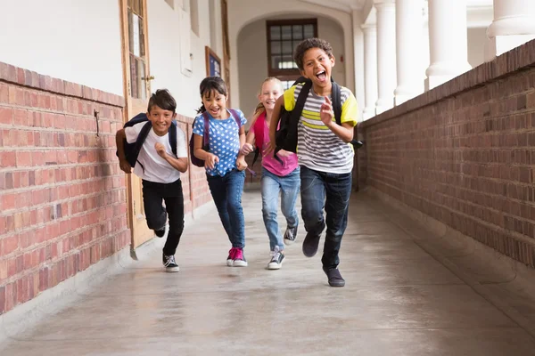 Cute pupils running down the hall — Stock Photo, Image