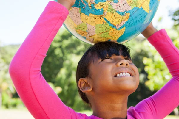 Cute little girl holding globe — Stock Photo, Image
