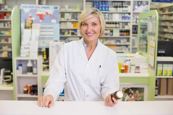 Farmacista sorridente che tiene il vaso della medicina — Foto Stock