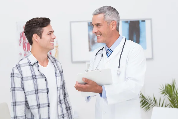 Доктор показує буфер обміну зі своїм пацієнтом — стокове фото