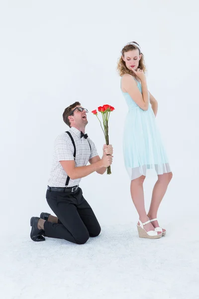 Geeky hipster begging his girlfriend taking roses — Stock Photo, Image
