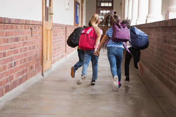 Cute pupils running down the hall — Stock Photo, Image