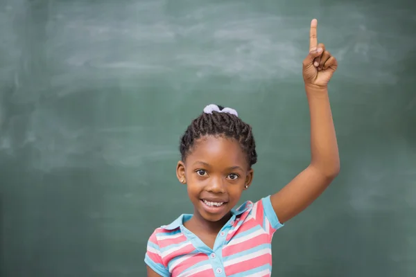 Pupils raising hand in classroom Stock Photo