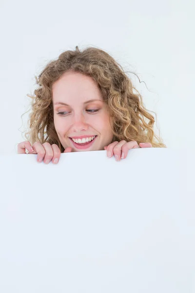 Hipster woman showing poster smiling at camera Royalty Free Stock Photos