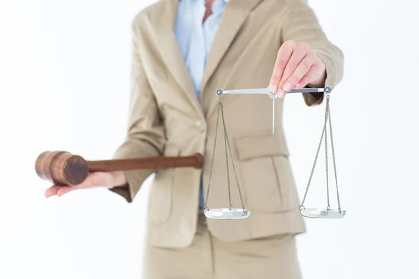 Young woman holding scales of justice and a gavel — Stock Photo, Image