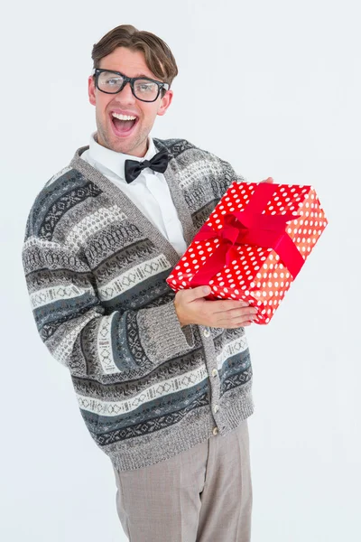 Happy geeky hipster with wool jacket holding present — Stock Photo, Image