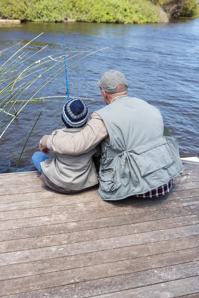 Father and son fihsing at a lake — Stock Photo, Image