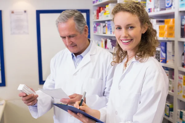 Pharmacists looking a medication for a prescription — Stock Photo, Image