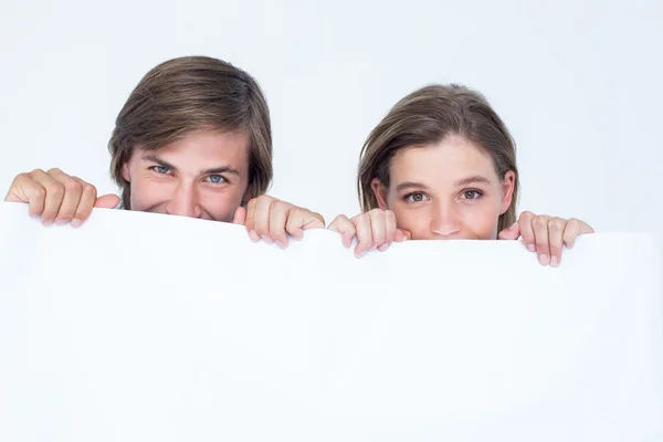 Hipster couple holding poster — Stock Photo, Image