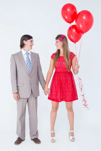 Geeky couple standing hand in hand — Stock Photo, Image