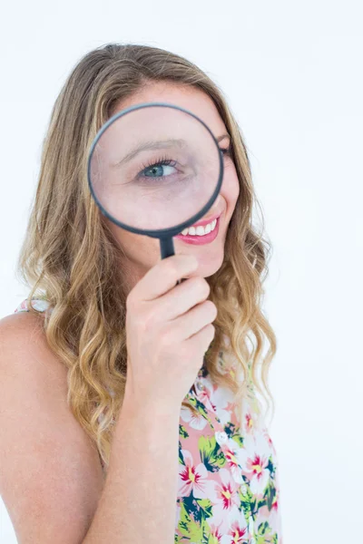 Smiling woman holding magnifying glass — Stock Photo, Image