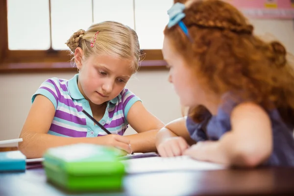 Pupils working hard at desk — Stock Photo, Image