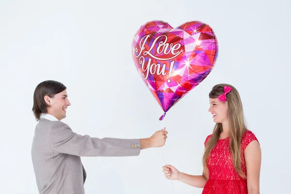 Hipster offering balloon to girlfriend — Stock Photo, Image