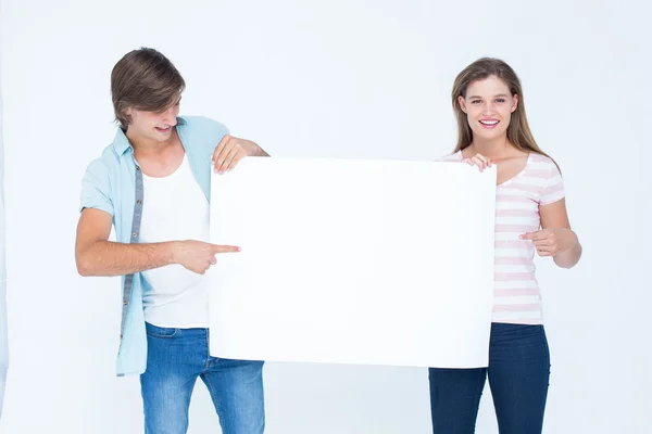 Hipster couple holding poster — Stock Photo, Image