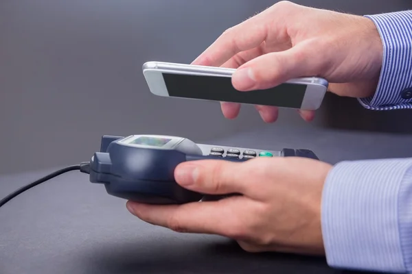 Man using smartphone to express pay — Stock Photo, Image