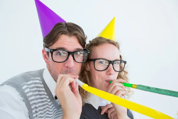 Geeky hipster couple blowing party horn — Stock Photo, Image