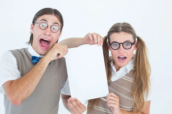 Geeky hipsters holding a poster — Stock Photo, Image