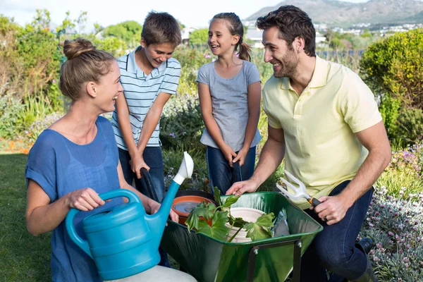 Happy young family gardening together — Stock Photo, Image