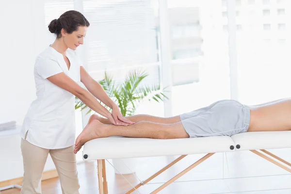 Physiotherapist doing calf massage to her patient — Stock Photo, Image