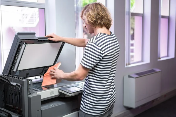 Student photocopying his book in the library — Stock Photo, Image
