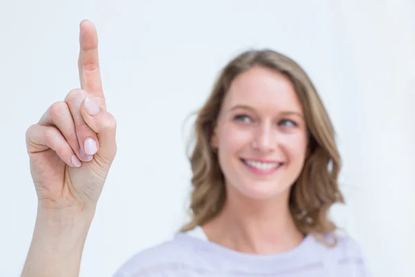 Pretty woman pointing with her finger — Stock Photo, Image
