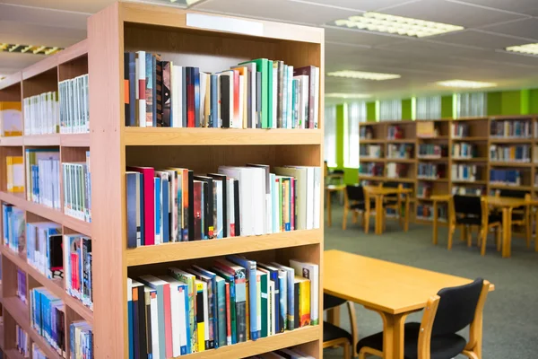 Volumes of books on bookshelf in library — Stock Photo, Image
