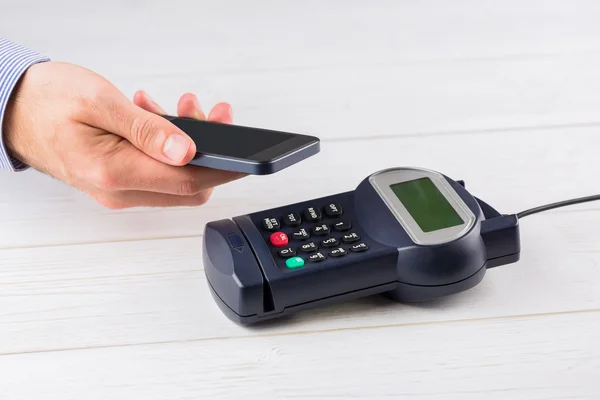 Man using smartphone to express pay — Stock Photo, Image