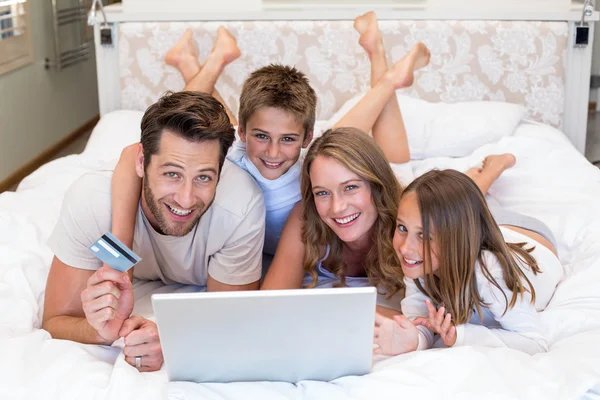 노트북을 사용 하 여 침대에 행복 한 가족 — 스톡 사진