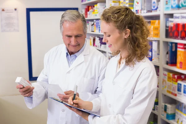 Pharmacists looking a medication for a prescription — Stock Photo, Image