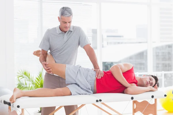 Fisioterapeuta haciendo masaje de piernas a su paciente —  Fotos de Stock
