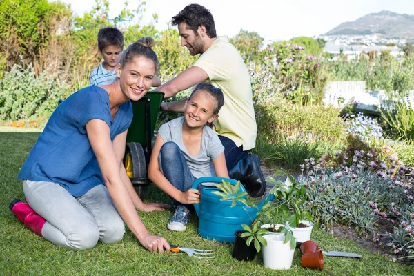 Happy young family gardening together — Stok Foto