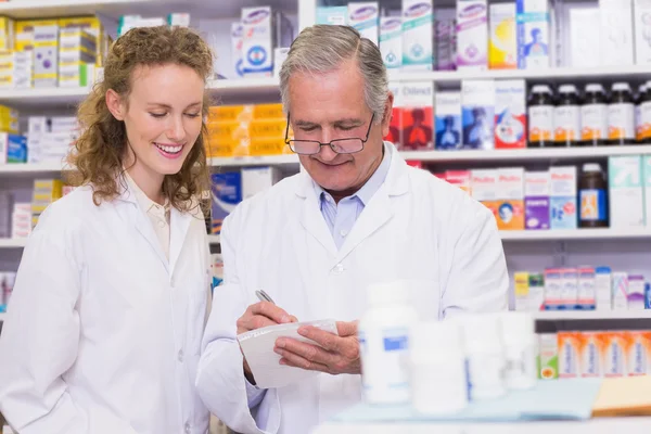 Pharmacists writing a prescription — Stock Photo, Image