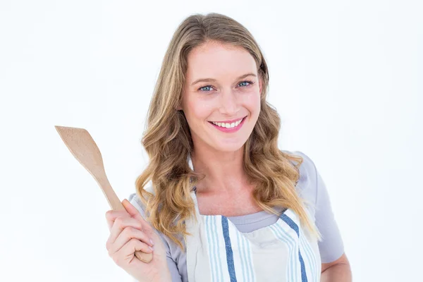 Smiling woman holding wooden spatula — Stock Photo, Image