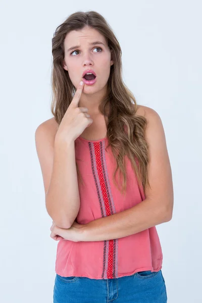 Surprised woman with finger on chin — Stock Photo, Image