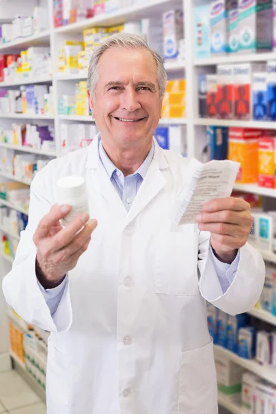 Senior holding medicine box and prescription — Stock Photo, Image