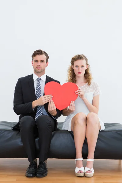 Geeky couple sitting on couch Royalty Free Stock Photos