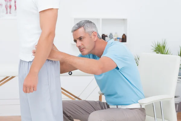 Doctor examining his patient back Royalty Free Stock Photos