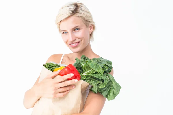 Atractiva mujer sosteniendo bolsa de verduras —  Fotos de Stock