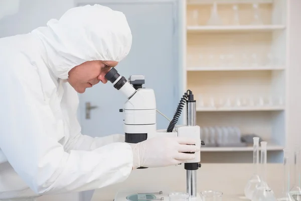 Scientist examining sample with microscope — Stock Photo, Image