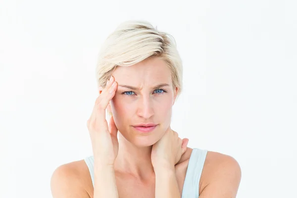 Blonde woman suffering from headache and neck ache — Stock Photo, Image