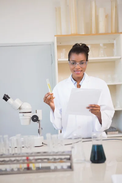 Scientist looking at camera and holding paper — Stock Photo, Image