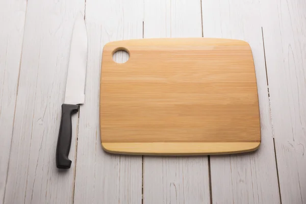 Chopping board with large knife — Stock Photo, Image