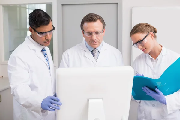 Scientists looking attentively at computer — Stock Photo, Image