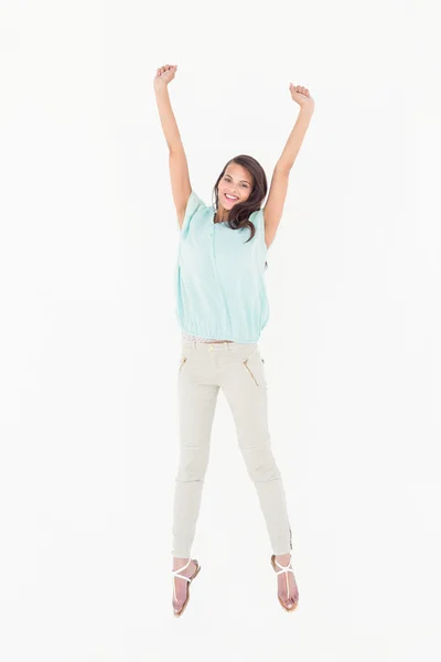 Pretty woman jumping looking at camera — Stock Photo, Image