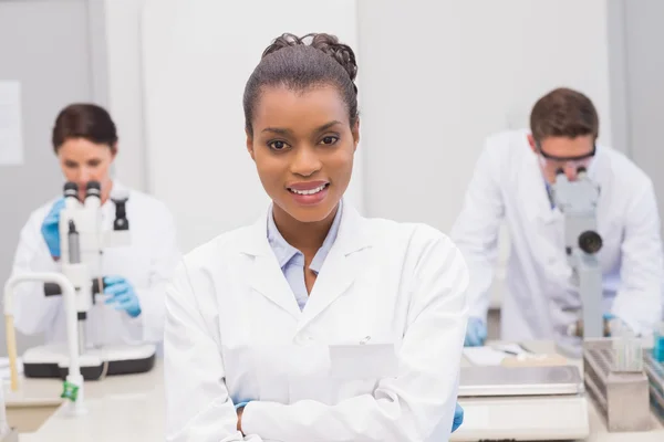 Scientist smiling at camera with arms crossed — Stock Photo, Image