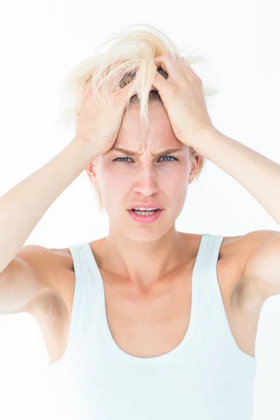 Sad blonde woman with head pain holding her head — Stock Photo, Image