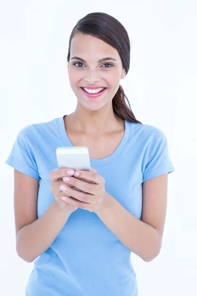 Happy brunette looking at her smartphone — Stock Photo, Image