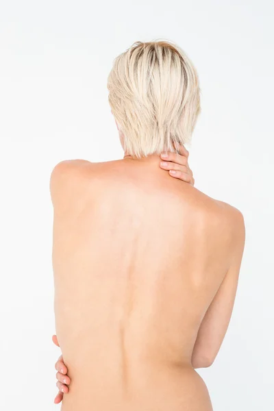 Beautiful topless woman touching her back — Stock Photo, Image