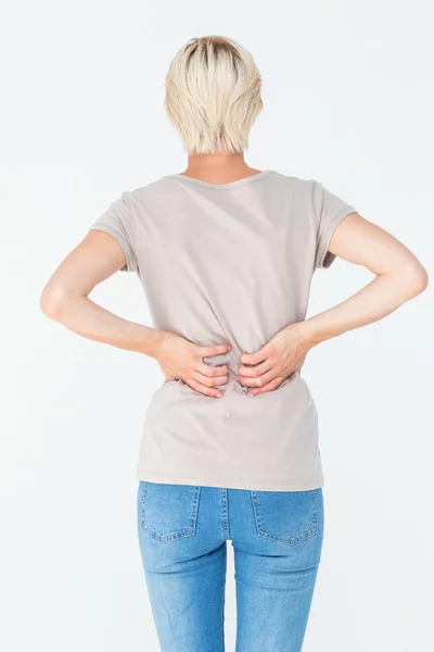 Mujer rubia que tiene un dolor de espalda y la celebración de su espalda —  Fotos de Stock